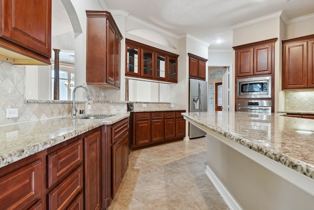 kitchen with sink, crown molding, stainless steel appliances, tasteful backsplash, and light stone countertops