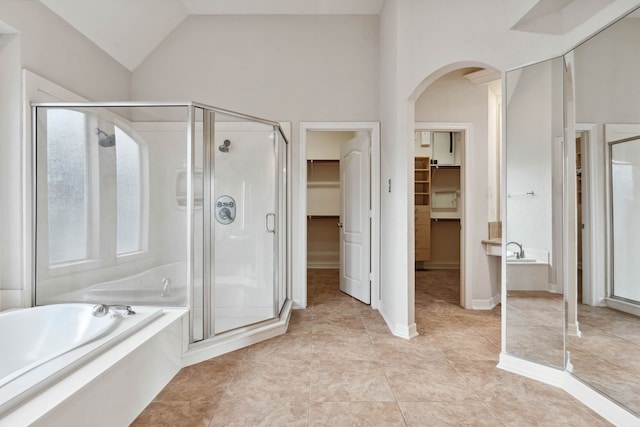 bathroom featuring separate shower and tub, lofted ceiling, and tile patterned floors