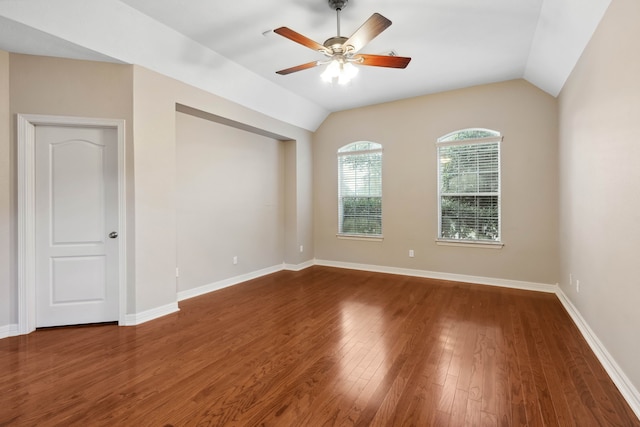 empty room featuring lofted ceiling, dark wood-type flooring, and ceiling fan