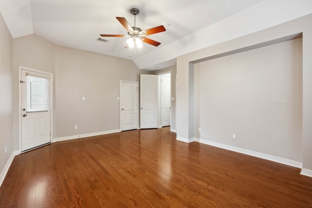 unfurnished bedroom with lofted ceiling, dark hardwood / wood-style floors, and ceiling fan