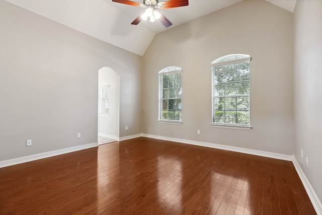 spare room with ceiling fan, dark hardwood / wood-style floors, and vaulted ceiling