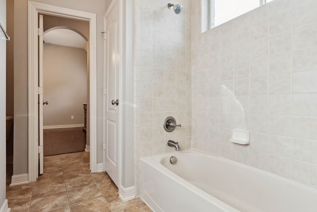 bathroom featuring tile patterned floors and tiled shower / bath combo