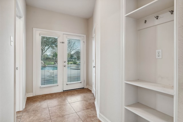 entryway featuring light tile patterned floors and french doors