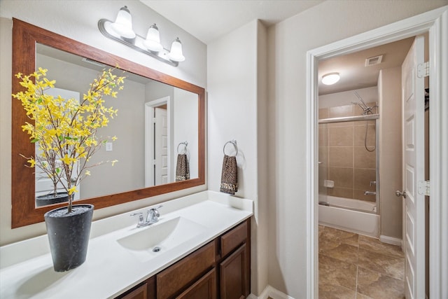 bathroom with combined bath / shower with glass door and vanity