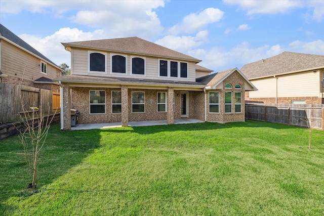 back of property featuring a patio area and a lawn