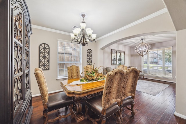 dining space with dark hardwood / wood-style floors, crown molding, and a notable chandelier