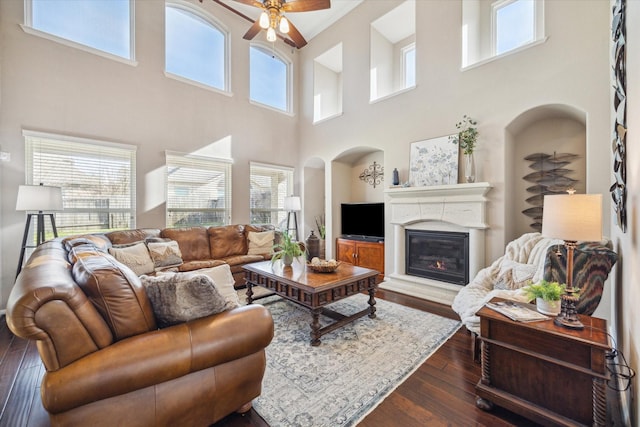 living room with dark hardwood / wood-style floors and ceiling fan