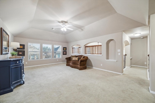 living area featuring ceiling fan, light carpet, and lofted ceiling