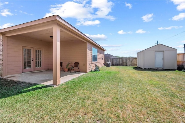 view of yard with a shed, central AC unit, a patio area, and french doors