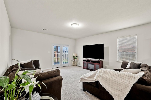 carpeted living room with french doors