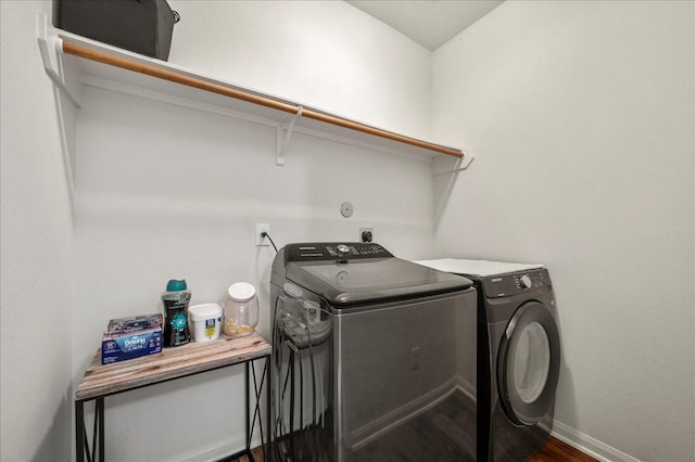 laundry room featuring dark hardwood / wood-style floors and washer and clothes dryer