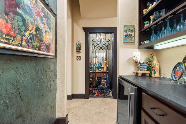 bar with light tile patterned floors and wine cooler