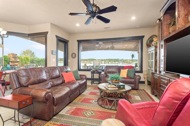 tiled living room with ceiling fan