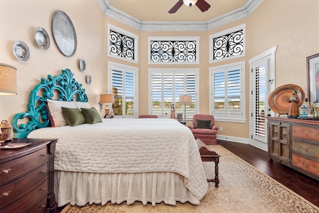 bedroom with a high ceiling, crown molding, hardwood / wood-style floors, and access to exterior