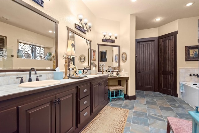 bathroom featuring vanity and a tub