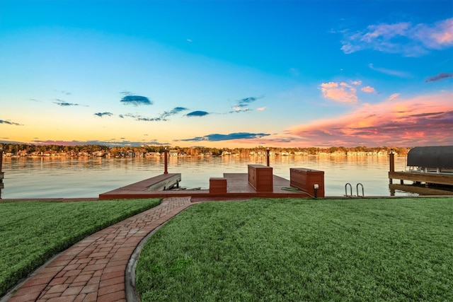 view of dock with a water view and a yard