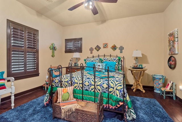 bedroom with dark hardwood / wood-style floors and ceiling fan