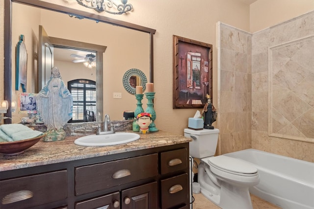 full bathroom featuring vanity, tiled shower / bath, ceiling fan, and toilet