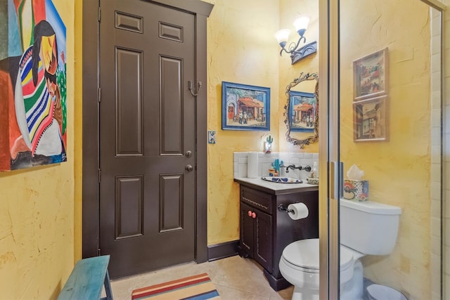 bathroom featuring vanity, tile patterned floors, and toilet