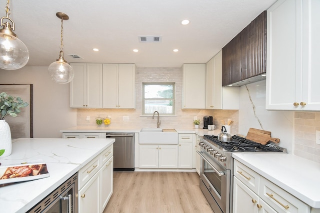 kitchen featuring sink, stainless steel appliances, and white cabinets