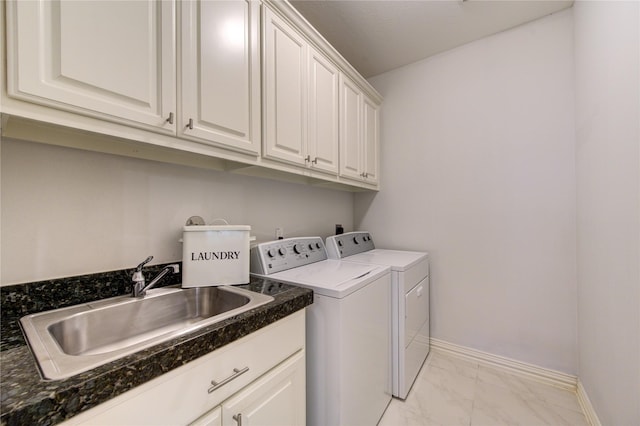 clothes washing area featuring cabinets, separate washer and dryer, and sink