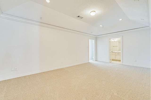 unfurnished bedroom featuring carpet floors and a tray ceiling