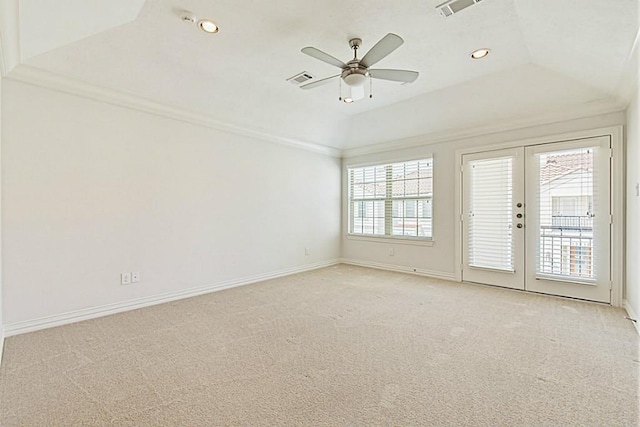 empty room with crown molding, ceiling fan, a tray ceiling, light colored carpet, and french doors