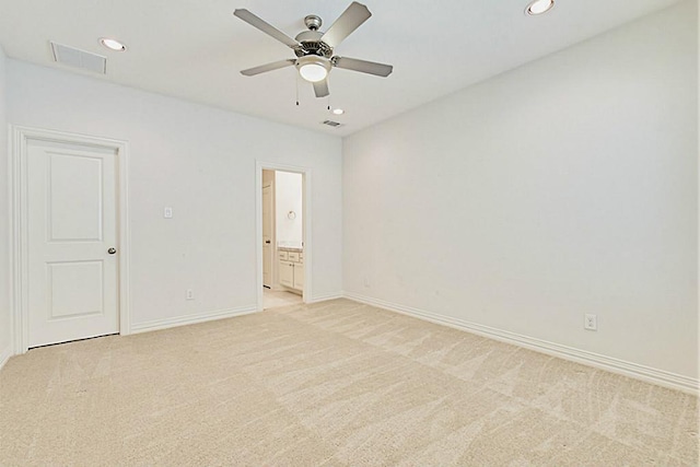 carpeted spare room with ceiling fan