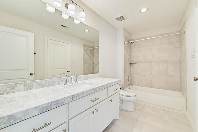 full bathroom with tiled shower / bath combo, vanity, tile patterned flooring, and toilet