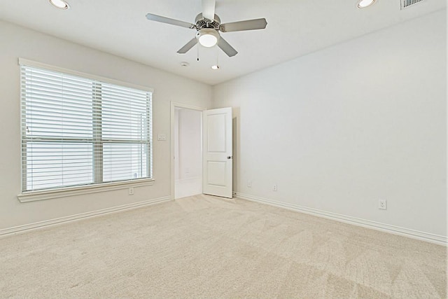 carpeted empty room featuring ceiling fan