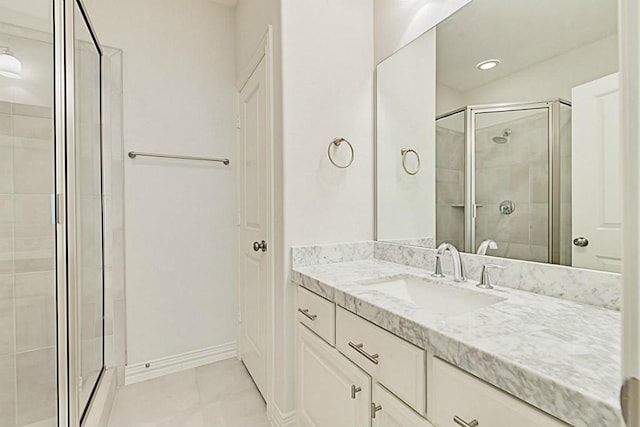 bathroom featuring an enclosed shower, vanity, and tile patterned flooring