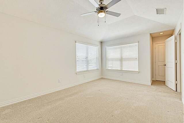 carpeted spare room featuring ceiling fan and vaulted ceiling