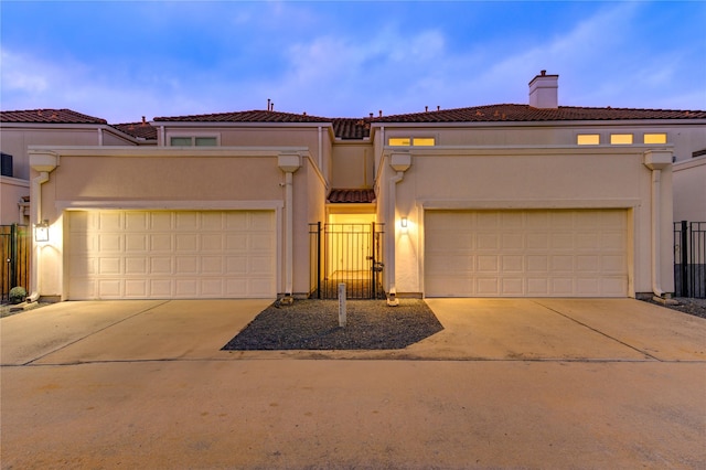 mediterranean / spanish-style home with a garage