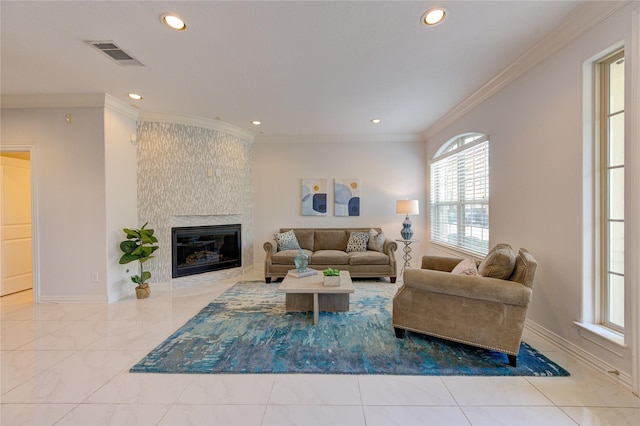 living room featuring a large fireplace and ornamental molding