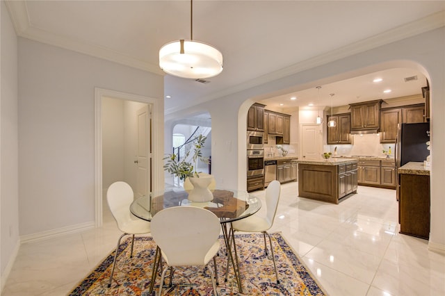 dining room featuring crown molding