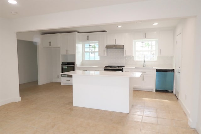 kitchen with sink, stainless steel appliances, white cabinets, and a kitchen island