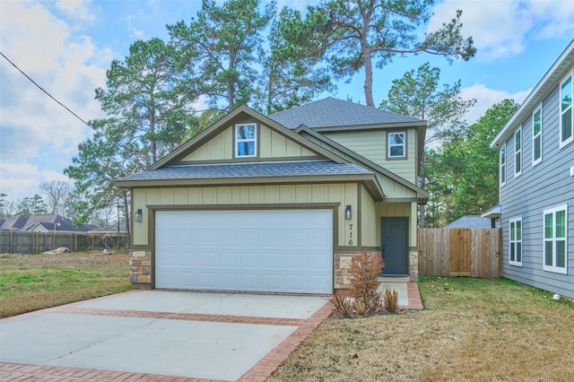 view of front of property featuring a garage and a front lawn