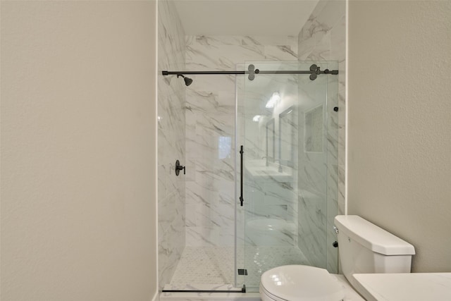 bathroom with an enclosed shower and toilet