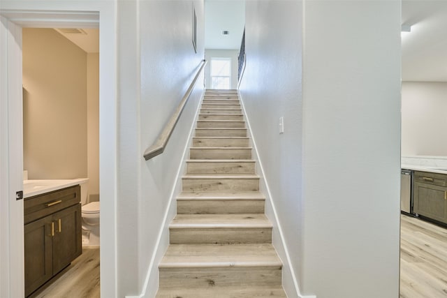 stairs featuring hardwood / wood-style floors