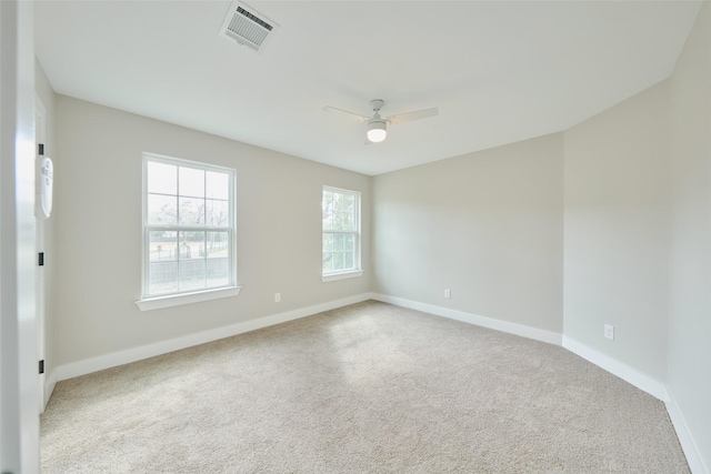 carpeted spare room featuring ceiling fan