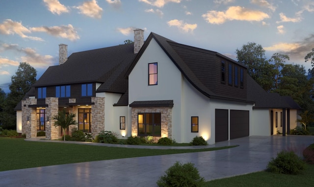 view of front facade with a garage and a lawn