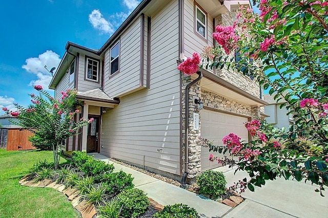 view of side of property with a yard and a garage