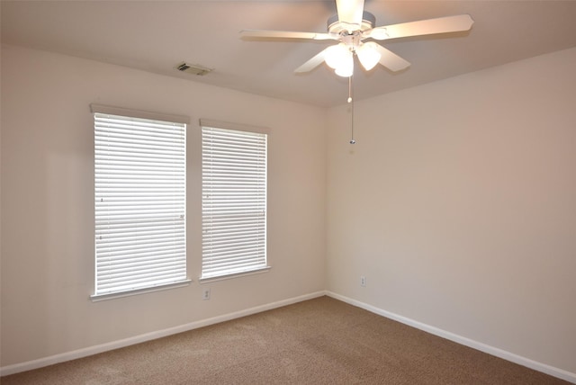 empty room with ceiling fan and carpet floors