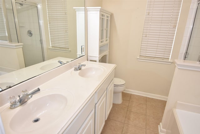 bathroom with tile patterned flooring, vanity, an enclosed shower, and toilet