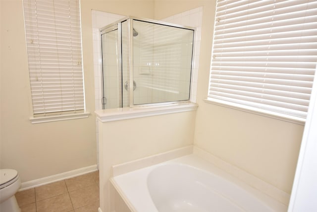 bathroom featuring toilet, tile patterned floors, and shower with separate bathtub