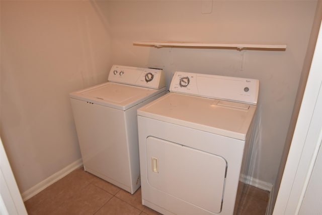 laundry room featuring washer and dryer and light tile patterned floors