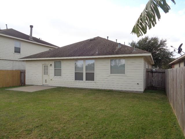 back of property featuring a patio and a yard