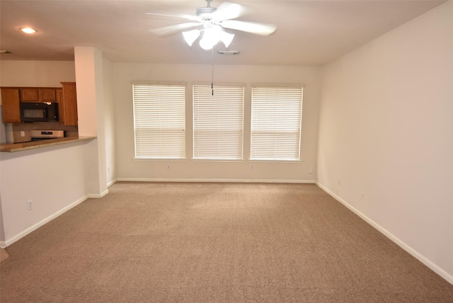 unfurnished living room with ceiling fan and carpet floors