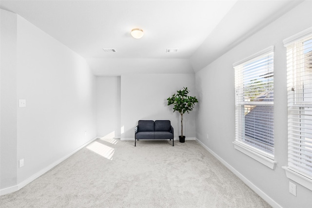 sitting room featuring baseboards, visible vents, vaulted ceiling, and carpet flooring