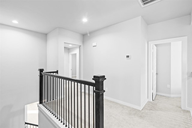 hallway with recessed lighting, visible vents, an upstairs landing, baseboards, and carpet